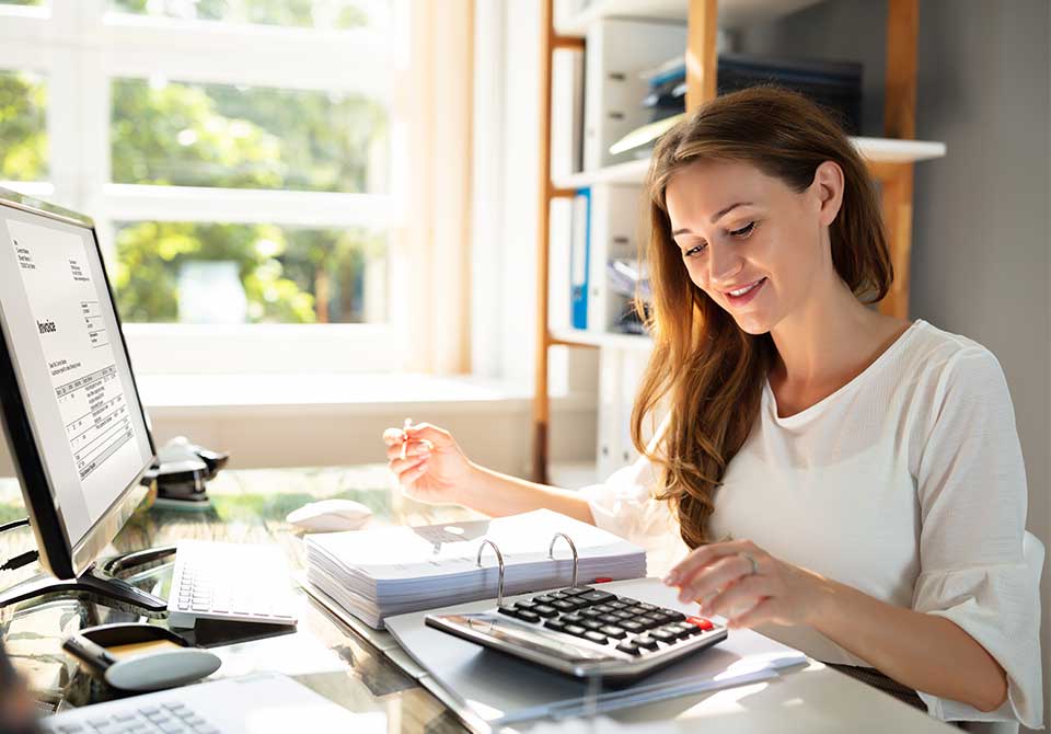 A young woman doing accounting work in a small office